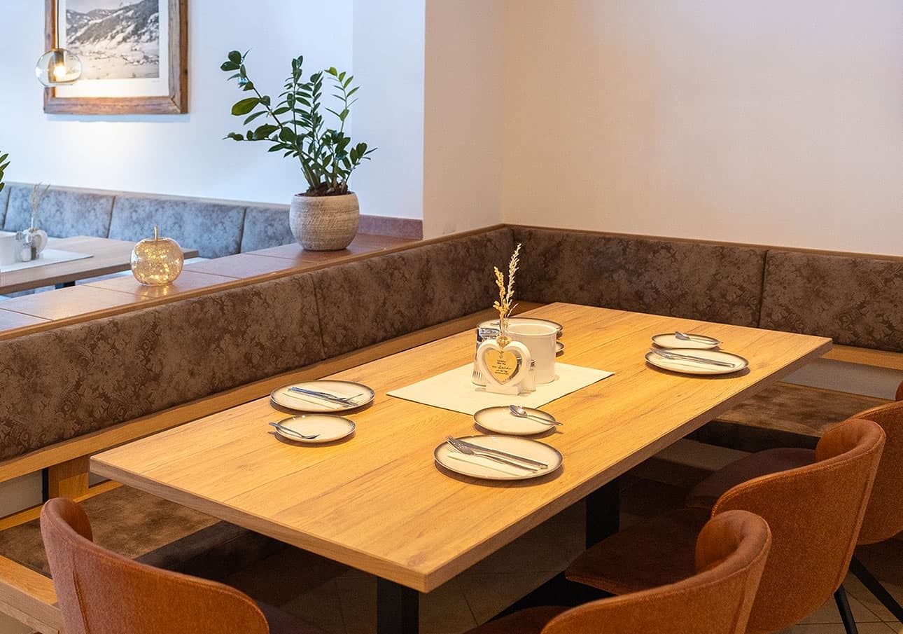A cozy restaurant table set for four with plates and utensils