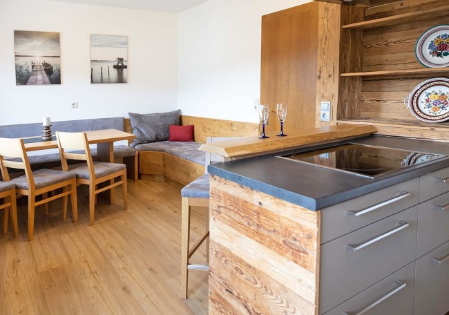 Cozy kitchen with wooden furniture and a small dining area with a corner bench