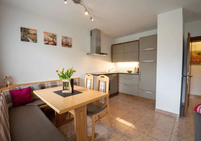 Modern kitchen with a wooden dining table and cozy seating area