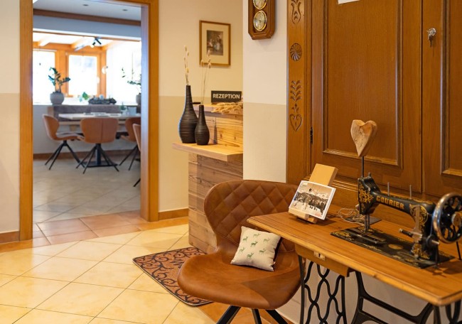 A cozy room with vintage decor and a sewing machine by the door